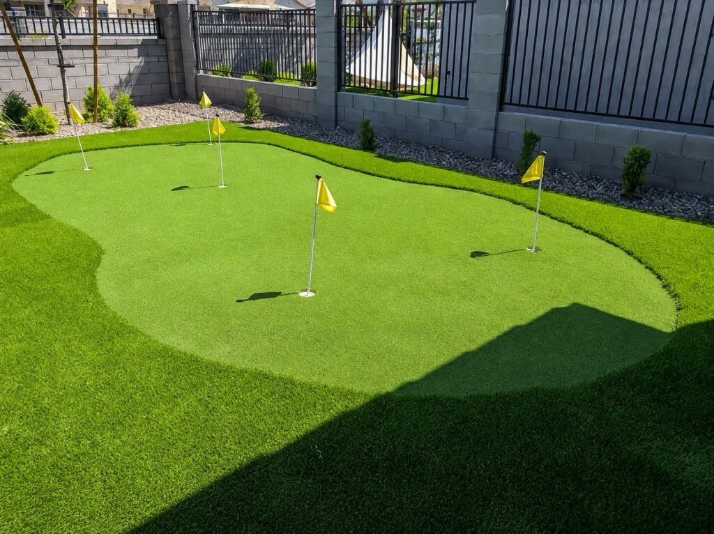 Backyard golf chipping area with synthetic turf and putting holes